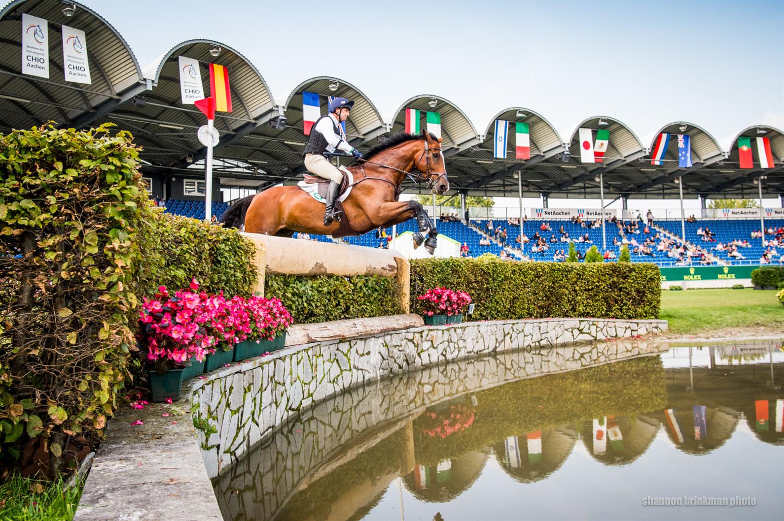 Wide-angle shot of Will Coleman and Off The Record jumping into water at Aachen