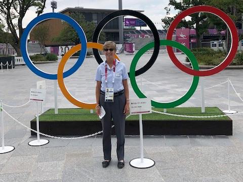 Jane Hamlin standing in front of the Olympic rings